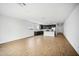 Spacious living area with modern kitchen, white island, and tile floors at 9533 W Luxton Ln, Tolleson, AZ 85353