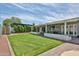 Green backyard with a manicured lawn, patio, mature trees, and privacy fence at 9851 N 28Th Way, Phoenix, AZ 85028