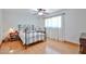 Bedroom showcasing a bed, hardwood floors, and window with natural lighting at 9851 N 28Th Way, Phoenix, AZ 85028