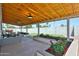Charming covered patio featuring a wood ceiling, outdoor seating, and decorative flower beds at 9851 N 28Th Way, Phoenix, AZ 85028