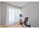 Bright exercise room featuring a stationary bike, gray brick wall, and natural light through sheer curtains at 9851 N 28Th Way, Phoenix, AZ 85028