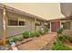 Charming walkway leading to the front entrance, accentuated with vibrant flowers and beautiful greenery at 9851 N 28Th Way, Phoenix, AZ 85028