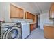 Functional laundry room featuring modern washer, dryer, and cabinet space for storage at 9851 N 28Th Way, Phoenix, AZ 85028