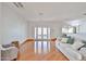 Bright living room with hardwood floors, white walls, and French doors, providing ample natural light at 9851 N 28Th Way, Phoenix, AZ 85028