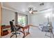Bright office featuring carpet flooring, a ceiling fan, a chair and access to the backyard at 9851 N 28Th Way, Phoenix, AZ 85028