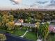 Expansive aerial view of the charming home, lush greenery, and a stunning city skyline backdrop at 1015 W Encanto Blvd, Phoenix, AZ 85007