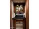 Charming bar area with custom cabinetry, wine fridge, glass storage and candle lighting at 1015 W Encanto Blvd, Phoenix, AZ 85007