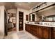Luxurious bathroom with custom wood cabinets, marble countertops, built-in shelving, and neutral tones at 1015 W Encanto Blvd, Phoenix, AZ 85007