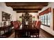 Elegant dining room with a large wood table, ornate chairs, chandelier lighting, and custom window coverings at 1015 W Encanto Blvd, Phoenix, AZ 85007