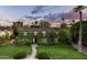 Beautiful ivy-covered home showcasing lush landscaping and a stone pathway to the entrance at 1015 W Encanto Blvd, Phoenix, AZ 85007