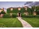 Charming home exterior covered in lush greenery with a stone pathway leading to the front door at 1015 W Encanto Blvd, Phoenix, AZ 85007