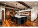 Custom kitchen featuring wood cabinetry, a marble island, and modern lighting at 1015 W Encanto Blvd, Phoenix, AZ 85007