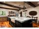 Stunning kitchen island featuring a marble countertop and farmhouse sink, complemented by wooden beams and pendant lighting at 1015 W Encanto Blvd, Phoenix, AZ 85007