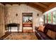 Comfortable living room boasts stone accent wall, hardwood floors, and comfortable leather furniture at 1015 W Encanto Blvd, Phoenix, AZ 85007