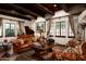 Elegant living room featuring high beamed ceilings, and leather furniture at 1015 W Encanto Blvd, Phoenix, AZ 85007