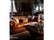 Comfortable living room with a leather sofa, patterned pillows, and a grand piano in the background at 1015 W Encanto Blvd, Phoenix, AZ 85007