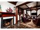 Living room boasts a red brick fireplace with a decorative mantel and exposed beams at 1015 W Encanto Blvd, Phoenix, AZ 85007