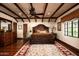 Spacious main bedroom featuring wood floors, beamed ceilings, decorative accents, and natural lighting at 1015 W Encanto Blvd, Phoenix, AZ 85007