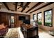 Well-appointed home office with custom wood paneling, stone wall accents, built-in storage, and large desk at 1015 W Encanto Blvd, Phoenix, AZ 85007