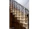 Elegant staircase with stone steps, wood accents, and decorative iron railings at 1015 W Encanto Blvd, Phoenix, AZ 85007