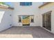 Back patio featuring pavers, sliding glass doors to the home, and a block wall for added privacy at 10324 W Sands Dr # 476, Peoria, AZ 85383