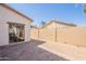 Paver patio and backyard with a view of the block wall and a peek at the neighboring house at 10324 W Sands Dr # 476, Peoria, AZ 85383