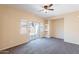 Bright bedroom with neutral walls, plush carpeting, ceiling fan, and built-in shelving at 10324 W Sands Dr # 476, Peoria, AZ 85383