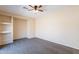 Neutral bedroom featuring plush carpeting, ceiling fan, and built-in shelving at 10324 W Sands Dr # 476, Peoria, AZ 85383