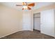 Neutral bedroom featuring carpet, ceiling fan, and an ample-sized closet space at 10324 W Sands Dr # 476, Peoria, AZ 85383