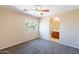 Bedroom featuring carpeted floors, a ceiling fan, and a window with backyard views at 10324 W Sands Dr # 476, Peoria, AZ 85383