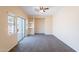 Light-filled bedroom features plush carpeting, a ceiling fan, and a sliding glass door to the backyard at 10324 W Sands Dr # 476, Peoria, AZ 85383