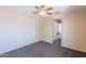 Bedroom featuring carpeted floors, a ceiling fan, and access to other rooms at 10324 W Sands Dr # 476, Peoria, AZ 85383