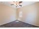 This bedroom features neutral walls, carpet, a window, and a ceiling fan at 10324 W Sands Dr # 476, Peoria, AZ 85383