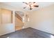 A view of the bedroom showing the staircase, which has a wooden railing, and an open doorway at 10324 W Sands Dr # 476, Peoria, AZ 85383