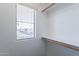 Walk-in closet featuring built-in shelving, hanging rods, and a window at 10324 W Sands Dr # 476, Peoria, AZ 85383