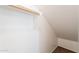 Attic closet area with a sloped ceiling, carpet, and a wooden rack for storage at 10324 W Sands Dr # 476, Peoria, AZ 85383