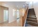 Inviting foyer with tile flooring, staircase, and views into the living space at 10324 W Sands Dr # 476, Peoria, AZ 85383