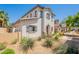 View of the home exterior with a textured white facade, tile roof, and desert landscaping at 10324 W Sands Dr # 476, Peoria, AZ 85383