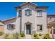 A two-story home with a white textured facade, a tile roof, and desert-style landscaping at 10324 W Sands Dr # 476, Peoria, AZ 85383