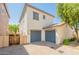 Front exterior of a two-story home featuring a two-car garage, desert landscaping and a paver driveway at 10324 W Sands Dr # 476, Peoria, AZ 85383