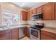 The kitchen has stainless steel appliances and a view through the window at 10324 W Sands Dr # 476, Peoria, AZ 85383
