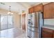 Kitchen showing stainless steel refrigerator and view to the outdoor patio at 10324 W Sands Dr # 476, Peoria, AZ 85383