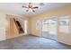 Open living area with sliding glass door to backyard, plush carpeting, and stairs to the second floor at 10324 W Sands Dr # 476, Peoria, AZ 85383
