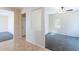 Bright, open room with neutral walls, ceiling fan, and adjacent tiled entry at 10324 W Sands Dr # 476, Peoria, AZ 85383