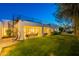 View of the backyard featuring covered patio, spiral staircase, and ample lawn space at 10532 N 79Th St, Scottsdale, AZ 85258