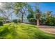 Lush green backyard with manicured lawn, mature trees, and well-maintained landscaping at 10532 N 79Th St, Scottsdale, AZ 85258