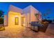 Backyard features a stone-paved patio with a built-in stainless steel grill and landscaping at 10532 N 79Th St, Scottsdale, AZ 85258