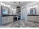 Large bathroom features dual vanities, a makeup area, a decorative shelving unit, and gray tile at 10532 N 79Th St, Scottsdale, AZ 85258