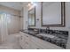 Bathroom featuring double sinks with granite countertop and elegant mirrors at 10532 N 79Th St, Scottsdale, AZ 85258