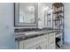Close up of bathroom with a stone countertop, vanity, makeup area, shelving unit, and light fixture at 10532 N 79Th St, Scottsdale, AZ 85258